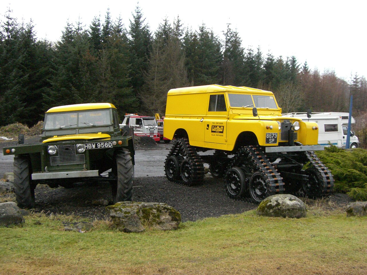 A vehicle, not the works: a Series II Cuthbertson four-track conversion (right) beside a Roadless Forest Rover, the two best-known British soft-ground Land Rover specials.