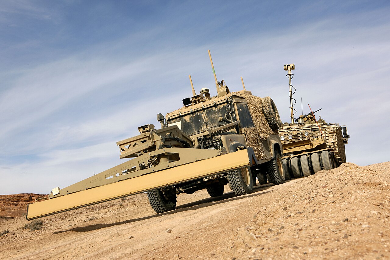 A vehicle, not the works: a Panama remote-control Land Rover converted by MIRA, carrying its ground-penetrating radar boom ahead of a Mastiff during Royal Engineers counter-IED training, December 2012.