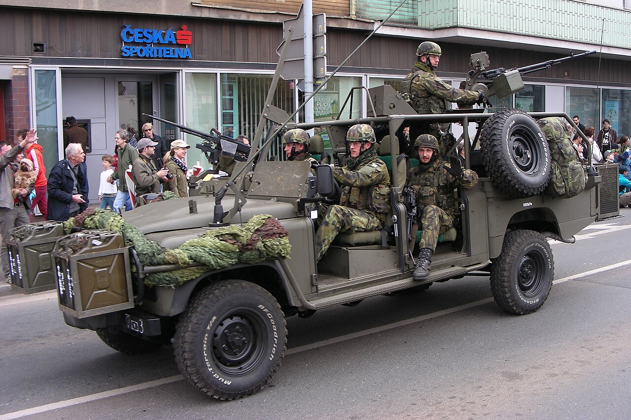 Czech Army Defender 130 Kajman with ring-mounted heavy machine gun and front jerry-can carriers on parade in Plzeň, 2015
