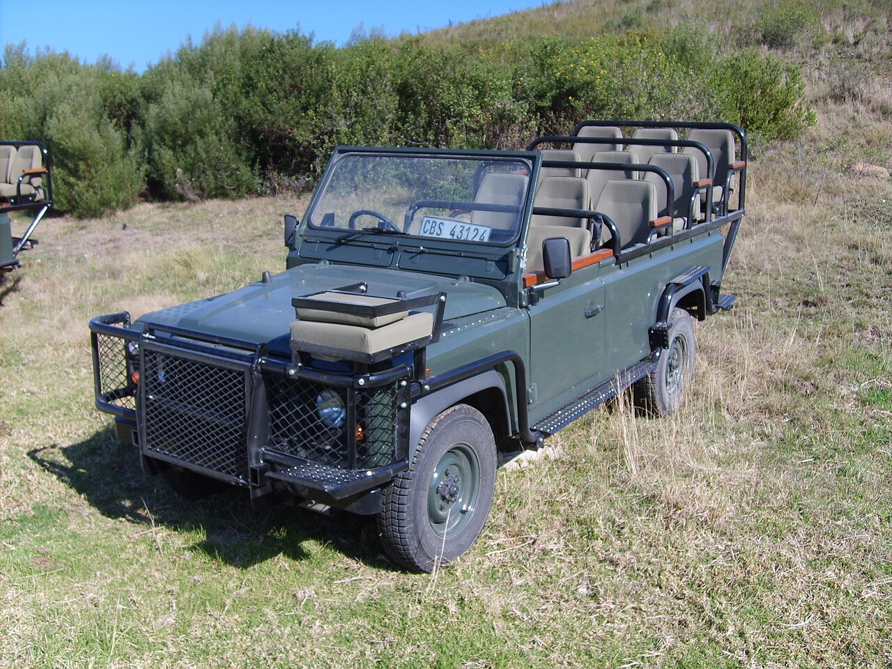 Long-wheelbase open Land Rover Defender game viewer with tiered seating at Gondwana Game Reserve, South Africa — the same conversion type as this record, not the catalogue's vehicle