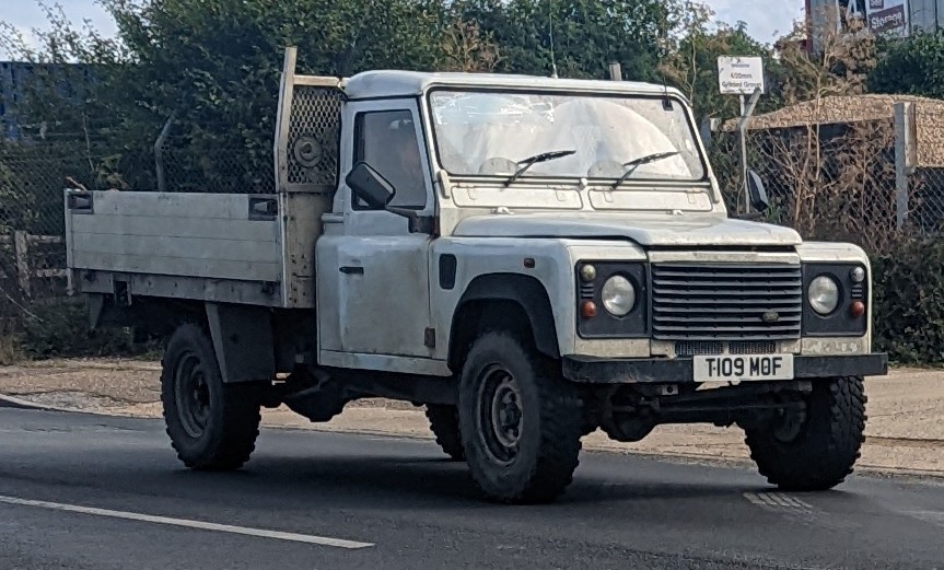 1999 Defender 130 with dropside utility body in workaday white