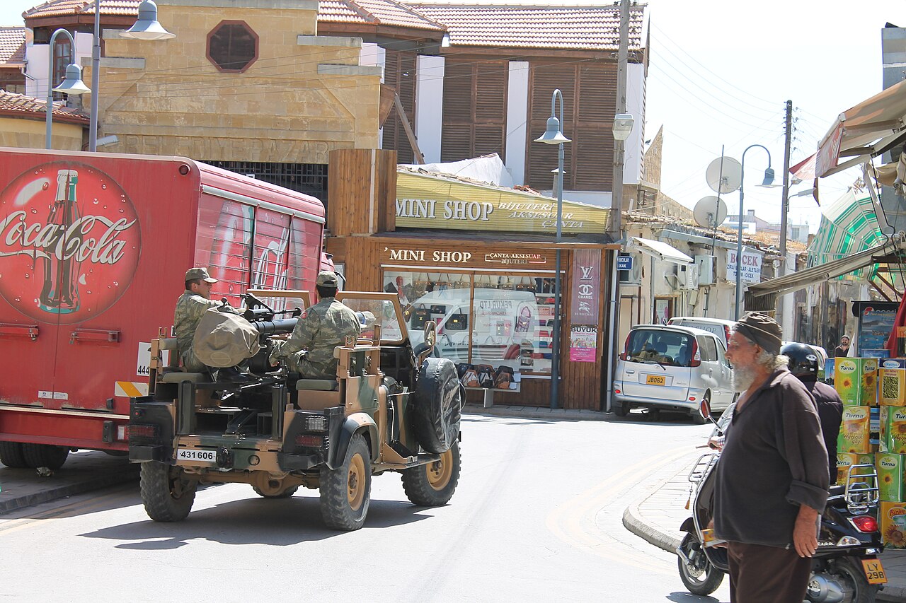 Turkish soldiers in an open soft-top Defender 90 with pedestal-mounted machine gun heading for the Green Line, North Nicosia, Cyprus, 2013