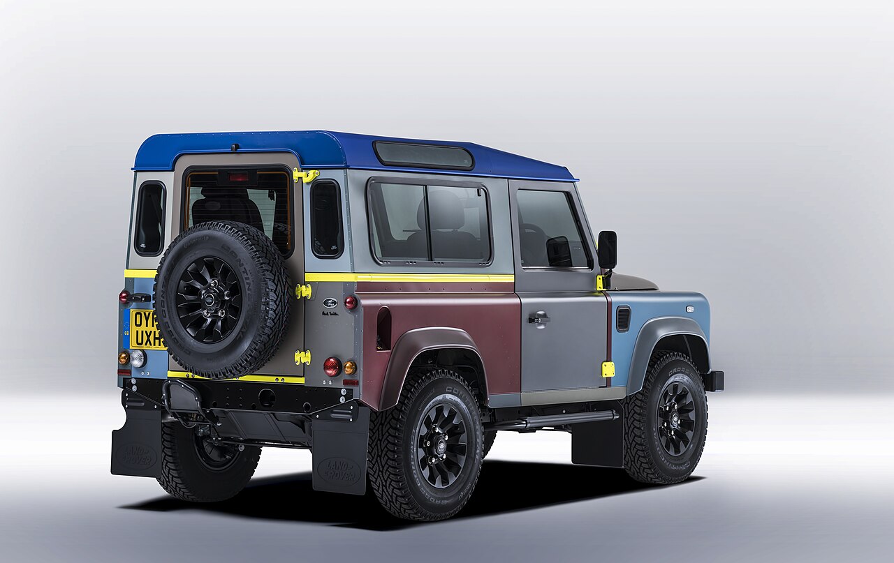 Rear three-quarter view showing the multicoloured panels and fluorescent yellow hinges