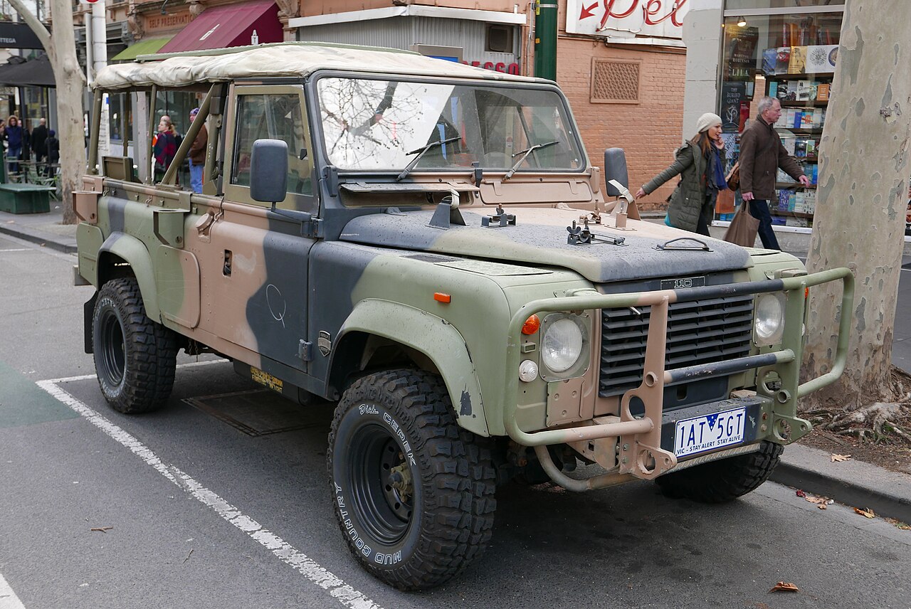 Preserved 1990 ex-Australian Army Perentie 110 in Auscam, Melbourne 2015. The paired antenna-base shrouds on the tray sides and the battery access door low on the tub identify it as a Fitted For Radio vehicle, although the photographer's title calls it a '110 County'.