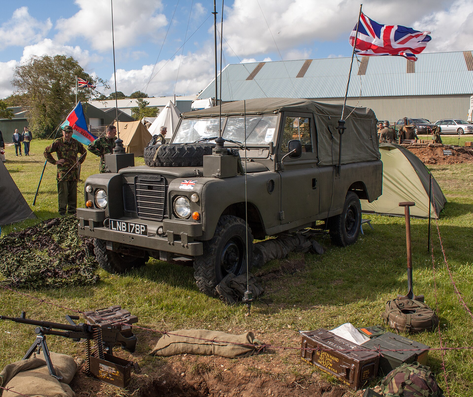 Preserved British Army Series III 109 FFR with canvas tilt and bonnet-mounted spare at a military vehicle display